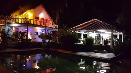 a house and a swimming pool at night at Cabaña en Prado Tolima in Prado