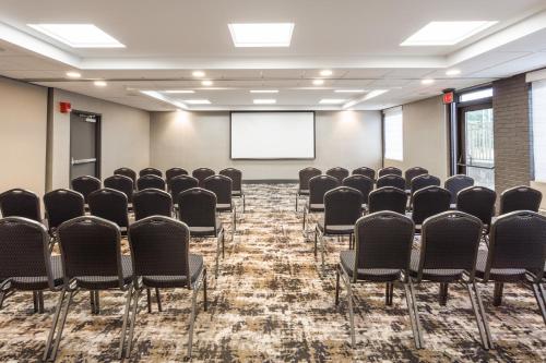 a conference room with chairs and a projection screen at Holiday Inn Roanoke Airport - Conference CTR by IHG in Roanoke