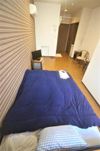 a large blue pillow sitting on top of a bed at Sakurakan in Minami Kyushu