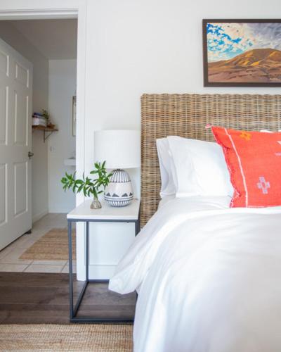 a bedroom with a bed and a side table at RubyJune Inn in White Salmon