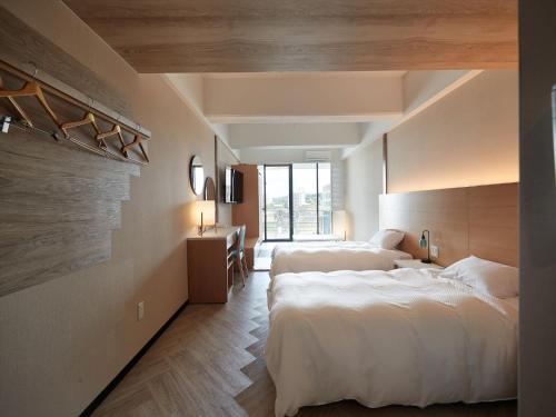 a hotel room with two beds and a window at Palace In Moon Beach in Onna