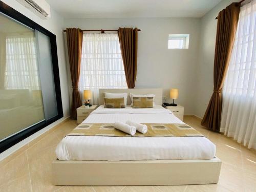 a bedroom with a large bed with two towels on it at MekongView 1 CondoTel in Phnom Penh