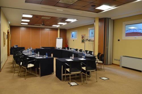 a conference room with tables and chairs in it at Bes Hotel Bergamo Ovest in Mozzo