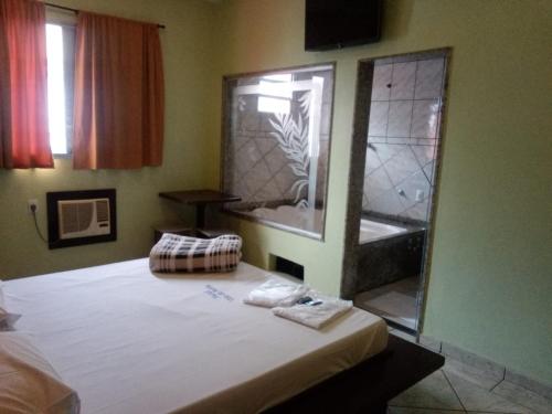 um quarto com uma cama grande e uma banheira em Hotel Villa da Penha em São Paulo