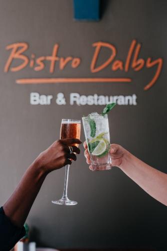 two people holding a drink in their hands at Novotel Newcastle Beach in Newcastle