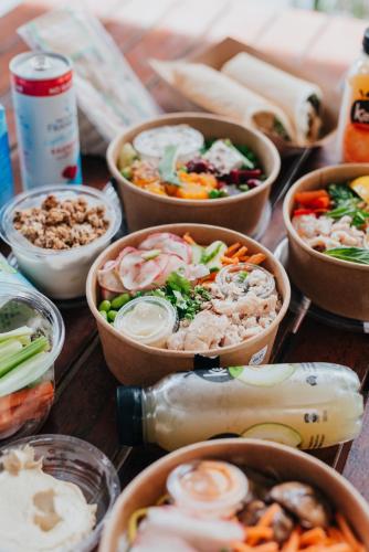 a table topped with bowls of different types of food at Novotel Newcastle Beach in Newcastle