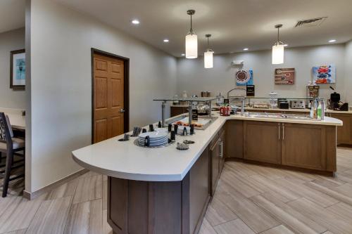 a large kitchen with a large island in the middle at Staybridge Suites Missoula by IHG in Missoula