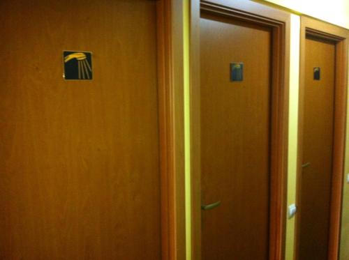 a hallway with two doors with a sign on it at Molodizhniy Hostel in Lviv