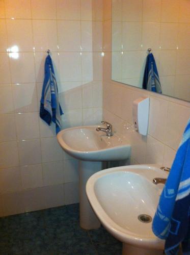 a bathroom with a sink and a mirror at Molodizhniy Hostel in Lviv
