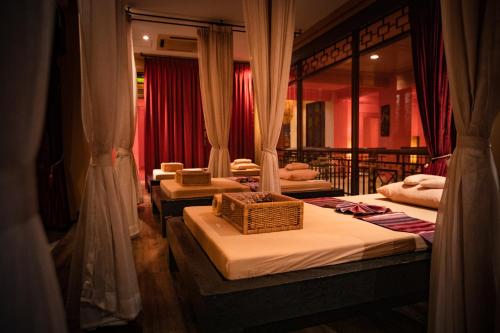 a group of four beds in a room at Shanghai Mansion Bangkok in Bangkok