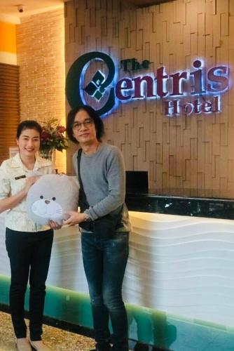 two women are holding a large teddy bear at The Centris Hotel Phatthalung in Phatthalung