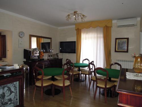 a living room with a dining room table and chairs at Sant'Agostino Guest Rooms in Paola