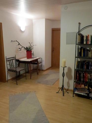 a living room with a table and a book shelf at Haus Matt in Laterns