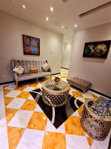 a living room with a couch and a checkerboard floor at West Liberty in Jeddah
