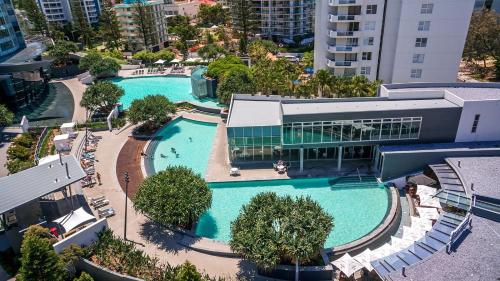 an overhead view of a large swimming pool with a building at Designer Rooms at Q1 resort - gclr in Gold Coast