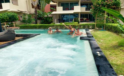 a group of people sitting in a swimming pool at Mama Beach Residence - Adults Only in Phi Phi Islands