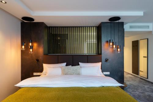 a bedroom with a large bed with a wooden headboard at Hotel Esplanade Dortmund in Dortmund