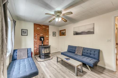 a living room with two blue couches and a fireplace at Hermitville in Rutland