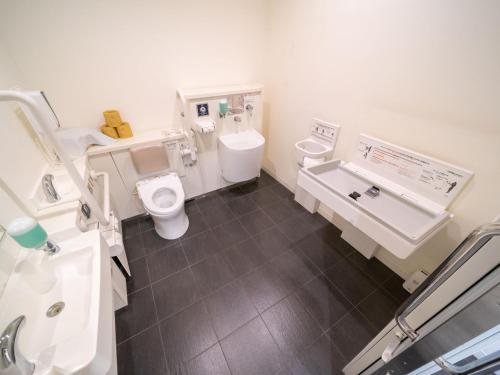 a bathroom with a toilet and a sink at Super Hotel Shinagawa Shinbanba in Tokyo