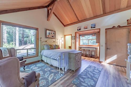 a bedroom with a bed and a large window at Dear Ol' Dad's Cabin in McKinleyville
