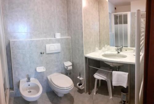 a bathroom with a toilet and a sink at Hotel Il Duca d'Este in Ferrara