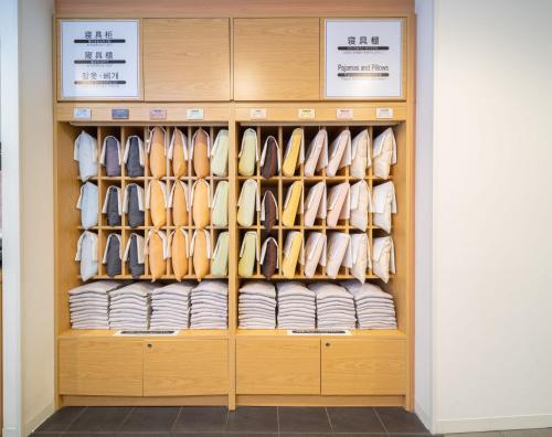 a display cabinet filled with lots of shoes at Super Hotel Shinagawa Shinbanba in Tokyo