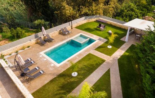 an overhead view of a backyard with a swimming pool at Kagiemar Luxury House in Perivólia