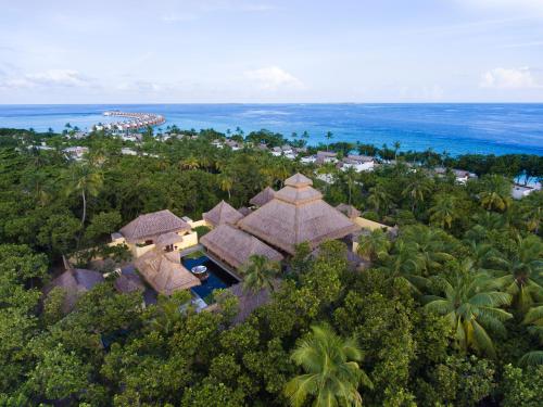 an aerial view of a resort with trees and the ocean at Emerald Maldives Resort & Spa-Deluxe All Inclusive in Raa Atoll