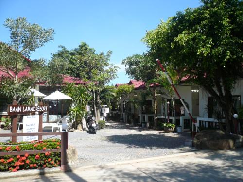 a street in a resort with flowers and trees at Baan Lamai Resort in Lamai