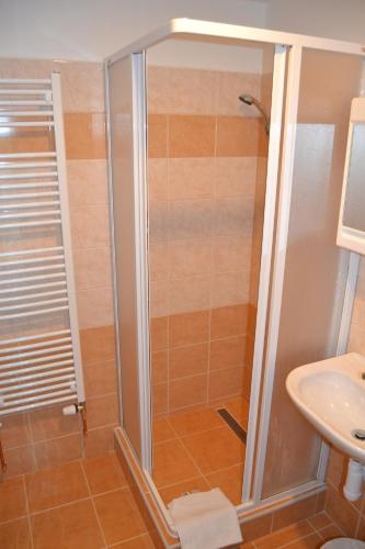 a bathroom with a shower and a sink at Hotel Bohemians in Prague