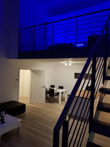 a room with a table and chairs and a blue light at WH Boardinghouse in Papenburg