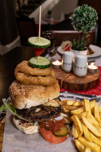a table with a sandwich and french fries at Gooderson Drakensberg Gardens Golf & Spa Resort in Drakensberg Garden