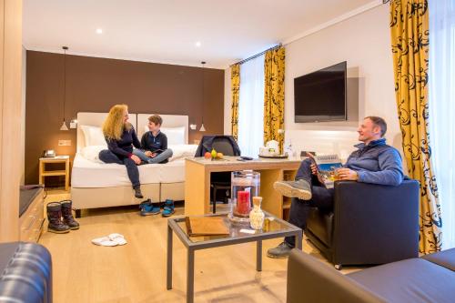 a group of people sitting in a hotel room at Belvedere Swiss Quality Hotel in Grindelwald