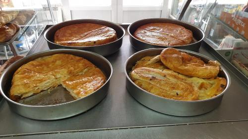 a group of four pans of pies on a counter at Lovely Private Flats FREE parking in Novi Sad