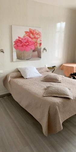 - une chambre dotée d'un lit avec des petits gâteaux roses dans l'établissement Hôtel restaurant les Templiers, à Montbard