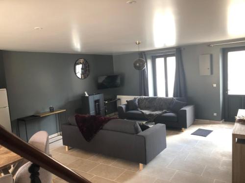 a living room with a couch and a chair at Maison de Pauline, Chablis Vineyard in Préhy