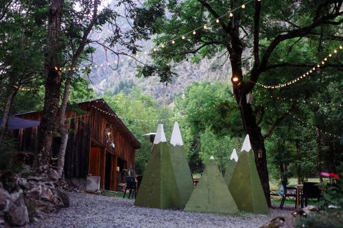 a group of green cones sitting next to a tree at Hotel Au Bon Accueil in Les Deux Alpes