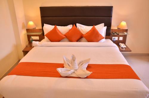 a bedroom with a large bed with a flower on it at LBD RESORTS & HOTELS KOLKATA in Kolkata