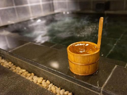 a bowl of peanut sauce with a wooden spoon on a counter at Super Hotel Shinagawa Shinbanba in Tokyo