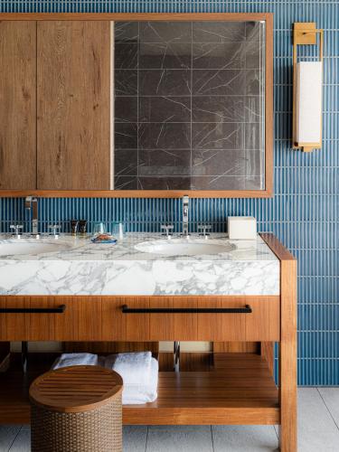 a bathroom with a sink and a large mirror at UMITO Okinawa Onnason in Onna