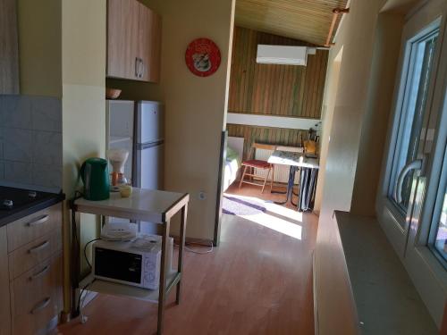 a small kitchen with a table and a refrigerator at Apartments and Rooms Knez in Portorož