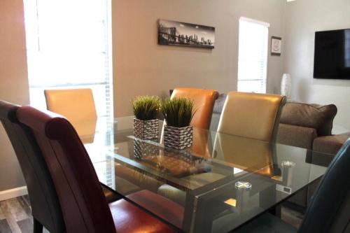 a living room with a glass table and chairs at CYC Eclectic Escape in San Antonio