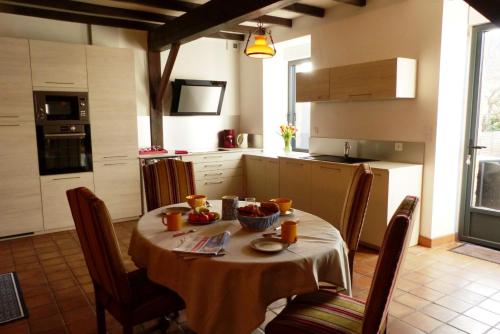 a kitchen with a table with a table cloth on it at Baden - Maison 4 personnes avec jardin et vue sur mer in Baden