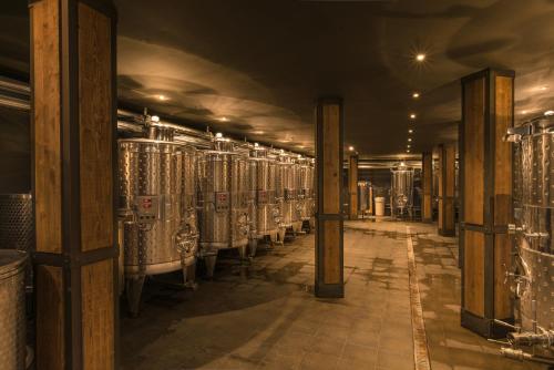 a wine cellar with rows of wine bottles at Zaara Estate Winery Hotel & SPA in Glavan