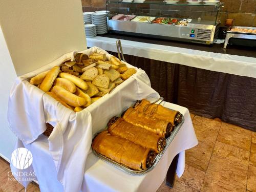 a tray of bread and other food on a table at Hotel Ondras z Beskyd in Ostravice