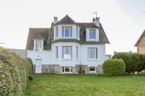 a large white house with a gray roof at CABESTAN - Maison de famille au coeur du bourg - Vue Mer in Carantec