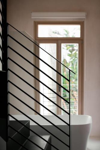 a spiral staircase in a room with a window at Sutor Chic Manor hotel in Rethymno Town