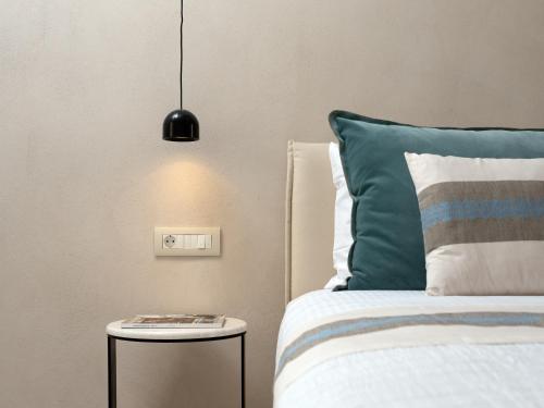 a bedroom with a bed and a side table at Sutor Chic Manor hotel in Rethymno Town