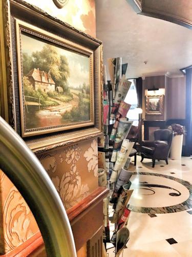 a room with a painting on the wall in a store at Frapolli Hotel on Deribasivska street in Odesa