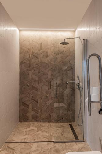 a shower with a glass door in a bathroom at Casa Néboa. in Negreira